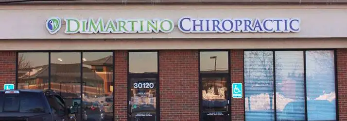 The front of the clinic. There is a sign above large windows that says DiMartino Chiropractic.