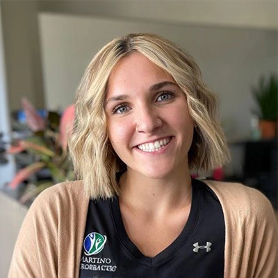 Madison Turski smiling in a tan sweater.