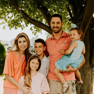 Eric DiMartino And Angela DiMartino smiling with their family.