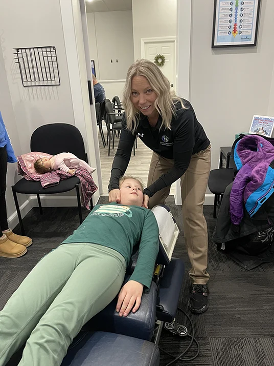 Chiropractor Chesterfield MI Janet Bednarz Kids Club Chiropractor Janet Bednarz adjusting a young girls neck.
