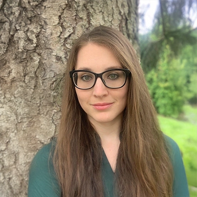 Chiropractor Whitney Pinson smiling in a green shirt.