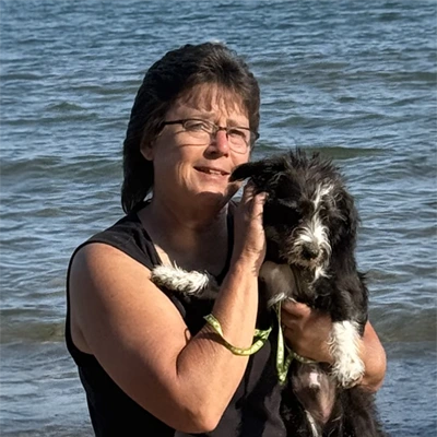 Marie Poliskey smiling with her dog.