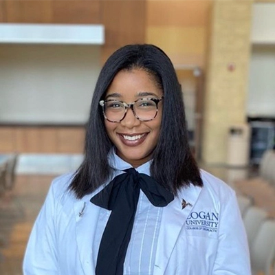 Chiropractor Amber Williams Smiling In Lab Coat